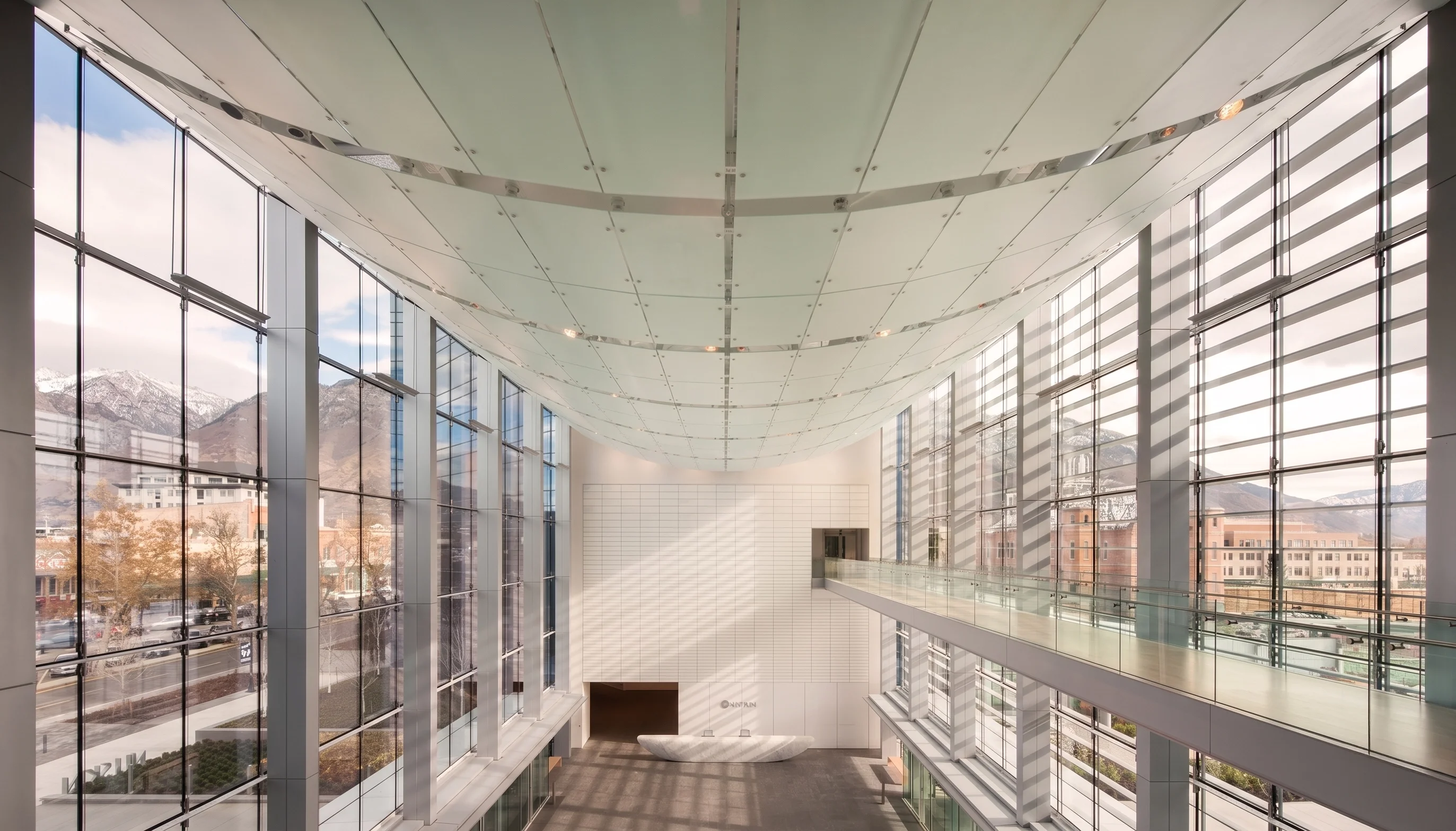 A clean, light glass space with curved frosted glass ceiling